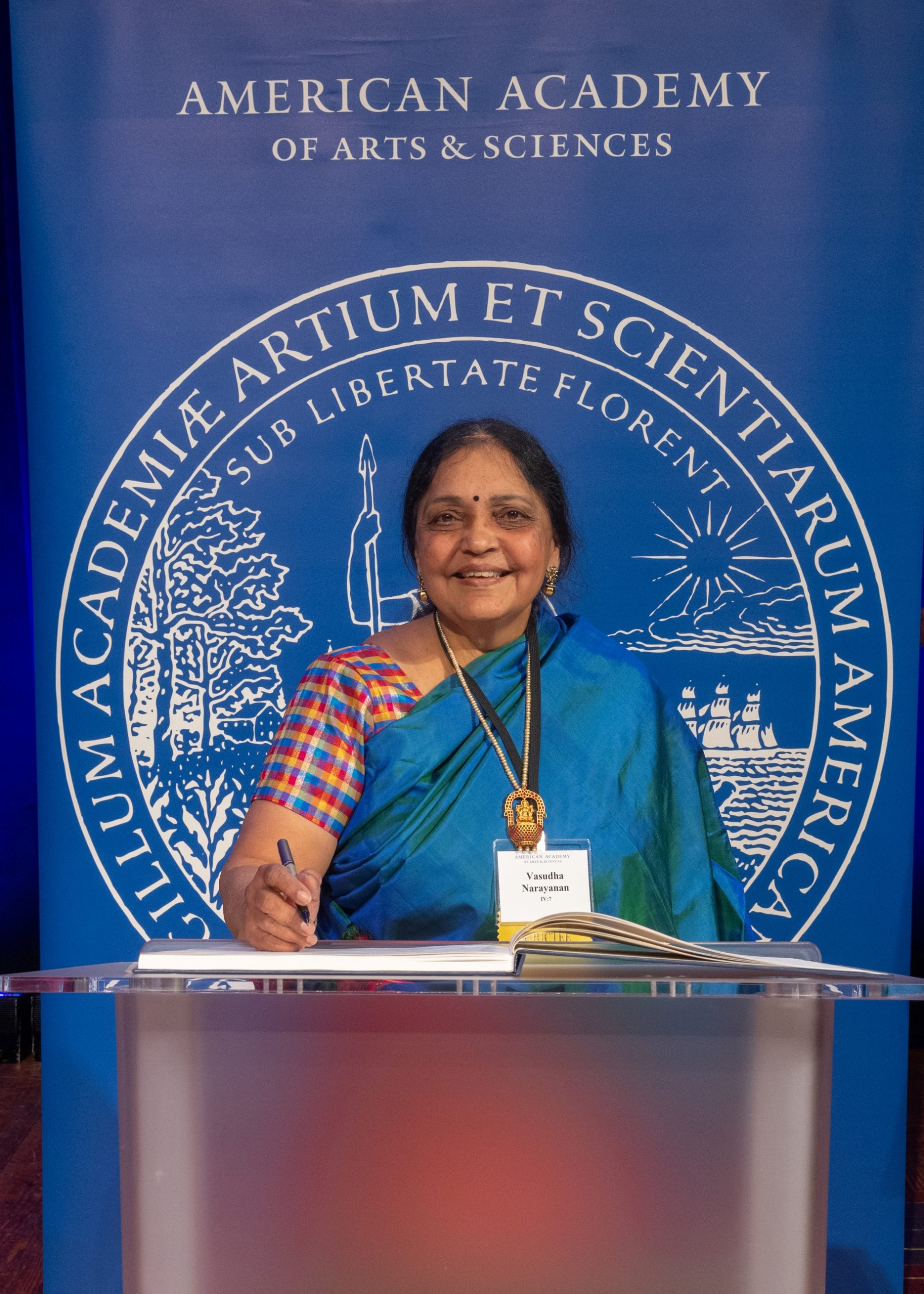 Dr. Vasudha Narayanan signing the register for the Academy that was founded in 1780 by John Adams and John Hancock