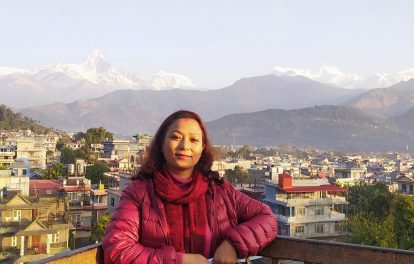 Photo of Rajani Maharjan in front of the city and mountains
